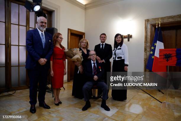 Renowned Albanian writer Ismail Kadare poses next to Albanian Prime Minister Edi Rama with his wife Linda Rama and members of his family after...