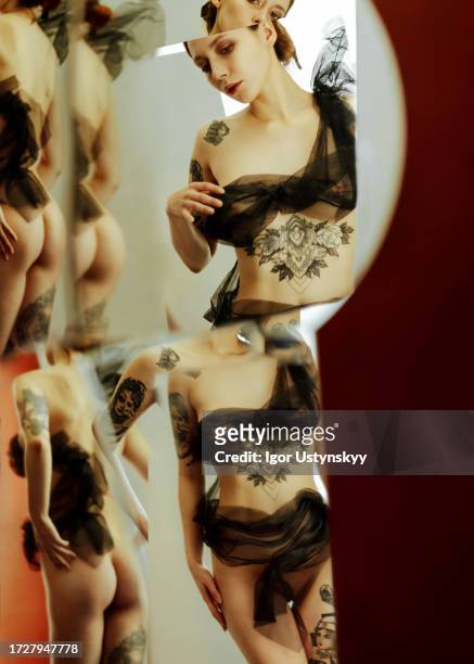 reflection of young semi-dressed woman in mirrors - the human body stock pictures, royalty-free photos & images