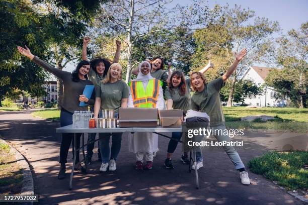 volunteers celbrating their success on fundraising and food and clothing banks - fundraising concept stock pictures, royalty-free photos & images