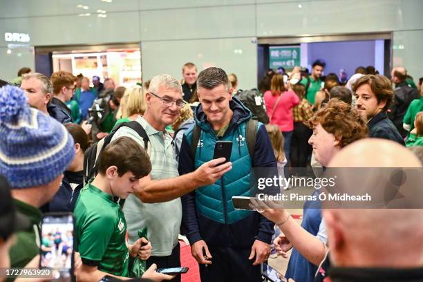 Dublin , Ireland - 16 October 2023; Captain Jonathan Sexton poses for a selfie with a supporter on the Ireland rugby teams arrival at Dublin Airport...