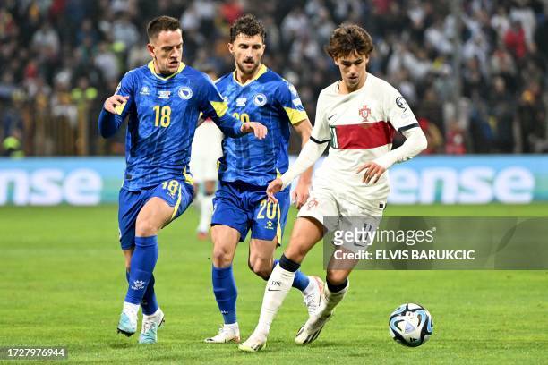 Portugal's forward Joao Felix controls the ball in front of Bosnia-Herzegovina's midfielder Amir Hadziahmetovic and Bosnia-Herzegovina's midfielder...