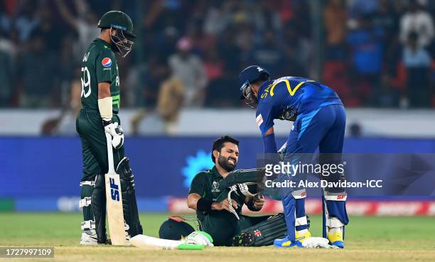 Mohammad Rizwan of Pakistan reacts as they are helped by Sadeera Samarawickramaof Sri Lanka during the ICC Men's Cricket World Cup India 2023 between...