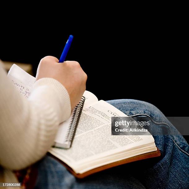 taking notes in church - bible stockfoto's en -beelden