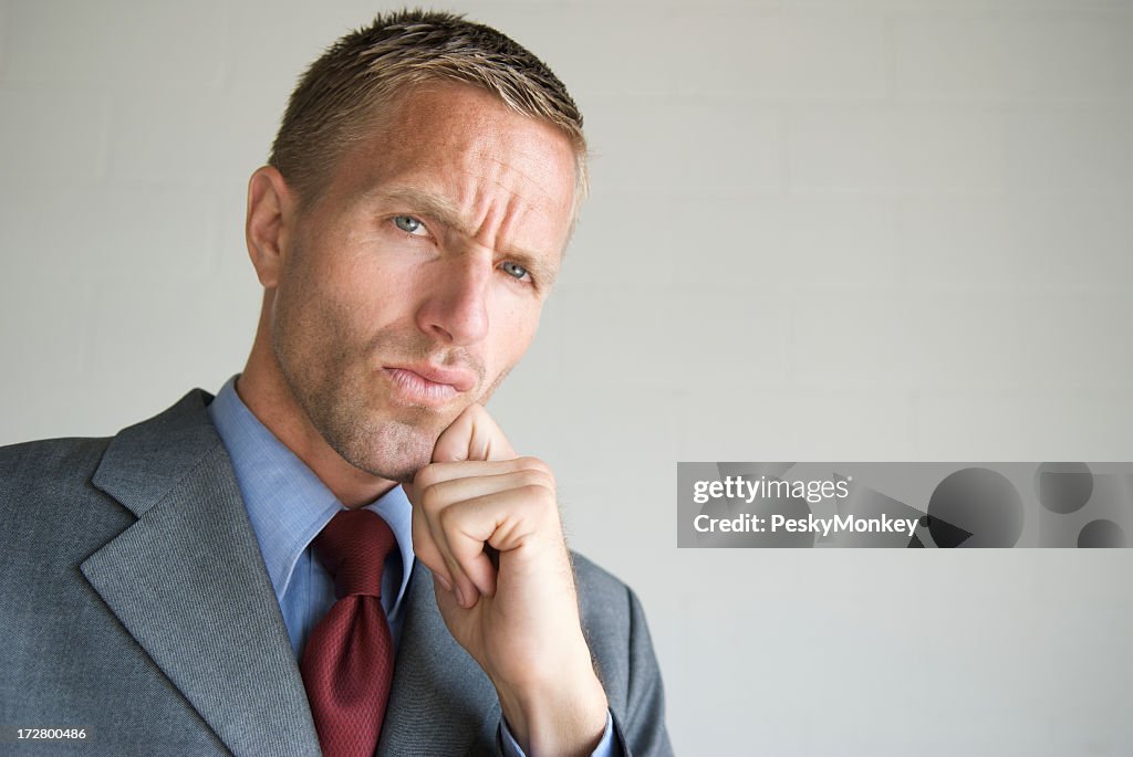 Cool Young Man Businessman Thinking with Hand on Chin