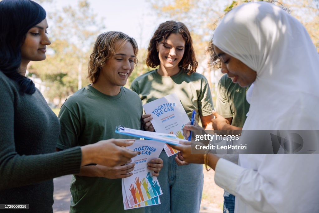Volunteers let people sign their fundraising and donation campaign