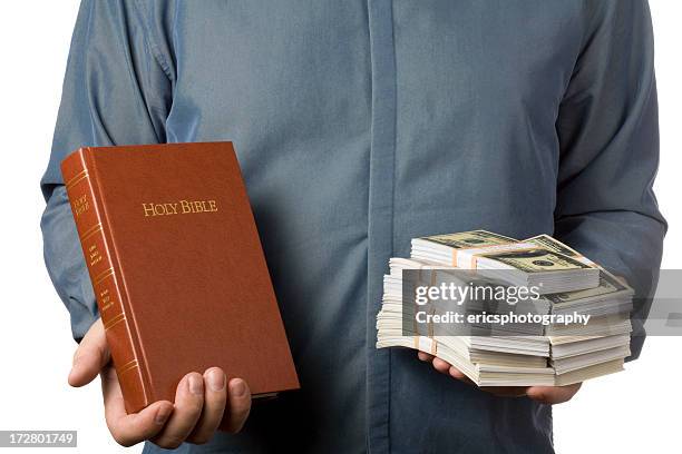man holding bible and money - bible money stock pictures, royalty-free photos & images