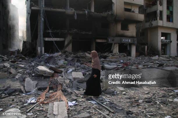 Palestinian citizens inspect damage to their homes caused by Israeli airstrikes on October 10, 2023 in Gaza City, Gaza. Almost 800 people have died...