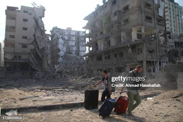 Palestinian citizens evacuate their homes damaged by Israeli airstrikes on October 10, 2023 in Gaza City, Gaza. Almost 800 people have died in Gaza,...