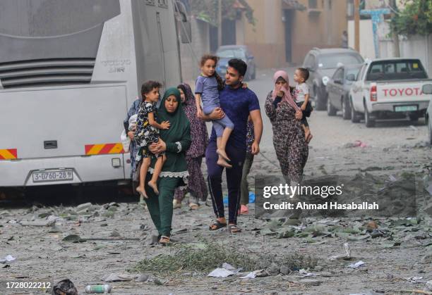 Palestinian citizens evacuate their homes damaged by Israeli airstrikes on October 10, 2023 in Gaza City, Gaza. Almost 800 people have died in Gaza,...