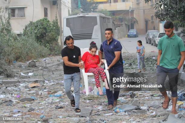 Palestinian citizens evacuate their homes damaged by Israeli airstrikes on October 10, 2023 in Gaza City, Gaza. Almost 800 people have died in Gaza,...