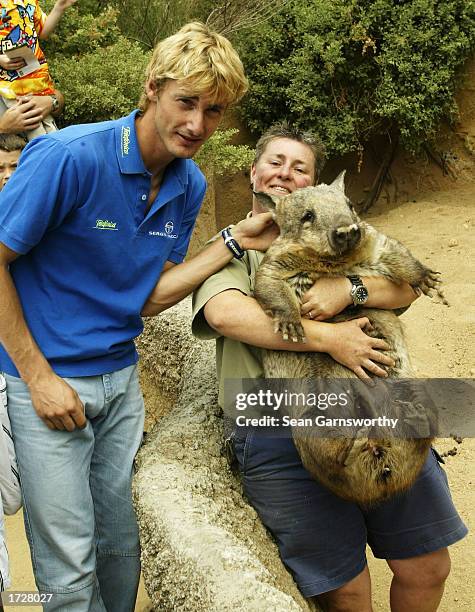 Juan Carlos Ferrero of Spain gets close to a wombat at Melbourne Zoo in Melbourne, Australia on January 16, 2003. .