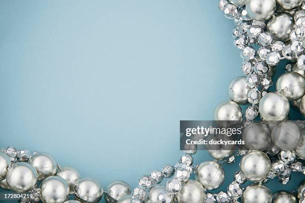 silver beads on blue - parel juwelen stockfoto's en -beelden