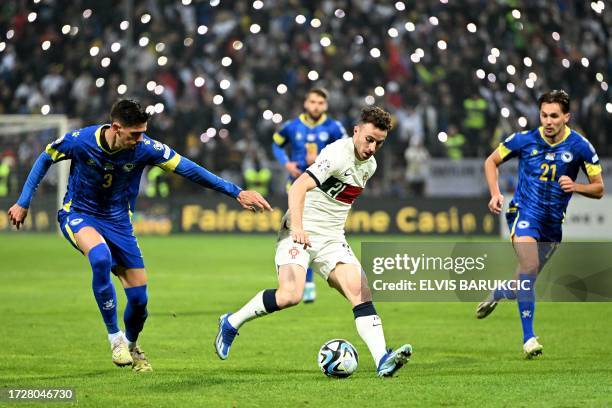 Portugal's forward Diogo Jota controls the ball next to Bosnia-Herzegovina's defender Dennis Hadzikadunic and Bosnia-Herzegovina's defender Amar...