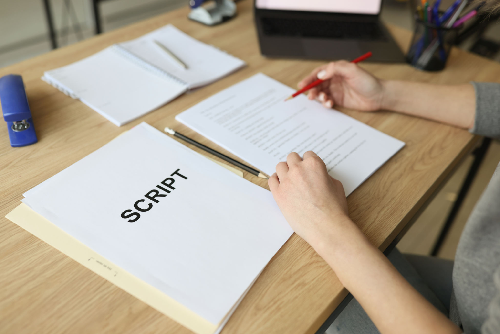 Actress checks script papers making notes with pencil Actress checks script papers making notes with pencil