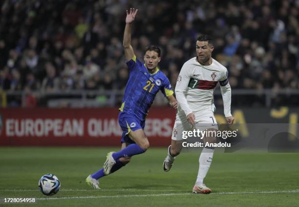 Cristiano Ronaldo of Portugal in action against Amar Dedic of Bosnia and Herzegovina during the Euro 2024 qualifying football match between Bosnia...