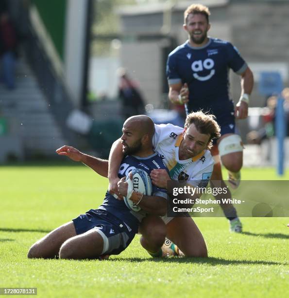 Sale Sharks' Tom O'Flaherty is tackled by Northampton Saints' James Ramm during the Gallagher Premiership Rugby match between Sale Sharks and...