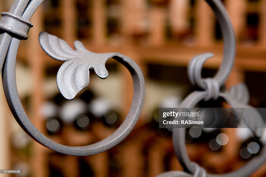 A curved wrought iron bar with leaf details