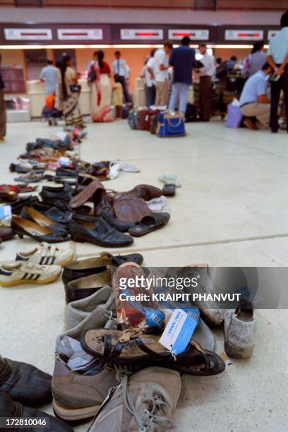 Bloodstained shoes lie unclaimed at the area departure of Karachi airport on September 7, 1986 as surviving passagers board after the Pan Am Flight...