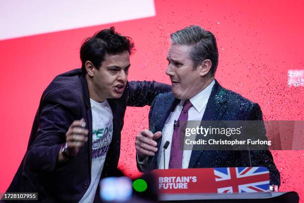 Protestor storms the stage and throws glitter over Labour party leader, Sir Keir Starmer during the leader's speech on the third day of the Labour...