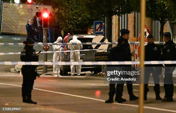 Police cordon off the area as personnel make inspections after a gunman killed at least two Swedish nationals in Brussels, Belgium on October 16,...