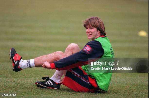 February 1997 England Football Squad training at Bisham Abbey, David Beckham sits down and puts on his boots.