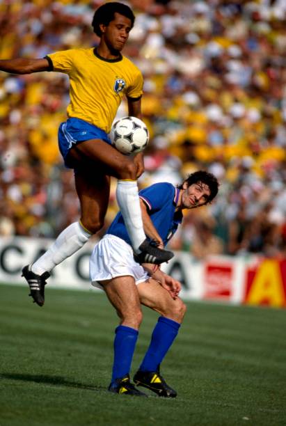 World Cup 1982, Spain, Brazil v Italy, Paulo Rossi ducks out of the way as Lusinho leaps in to win the ball.