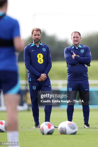 Gareth Southgate, Manager of England men's senior team, and Steve Holland, Assistant Manager of England look on during a training session at St...