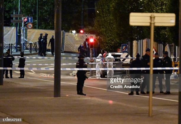 Police cordon off the area as personnel make inspections after a gunman killed at least two Swedish nationals in Brussels, Belgium on October 16,...