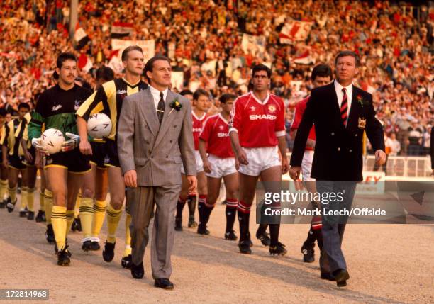 May 1990 FA Cup final replay - Crystal Palace v Manchester United - Palace manager Steve Coppell leads out his Palace team alongside Alex Ferguson in...