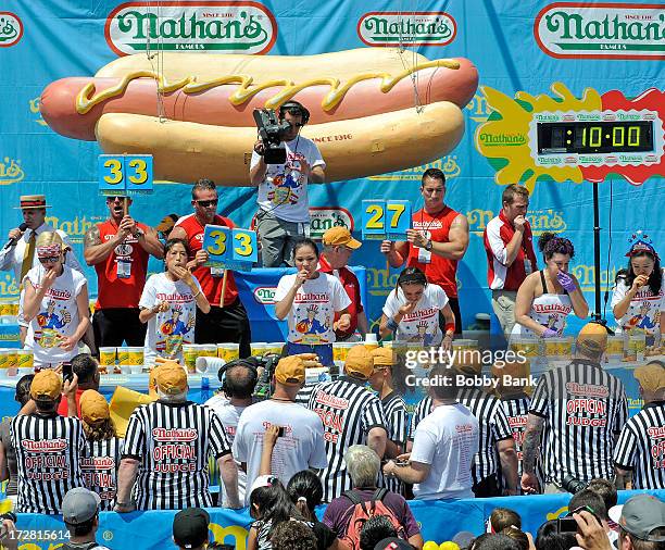 Sonya Thomas and Juliet Lee compete in the Woman's division of the 2013 Nathan's Famous Hot Dog Eating Contest at Coney Island on July 4, 2013 in New...