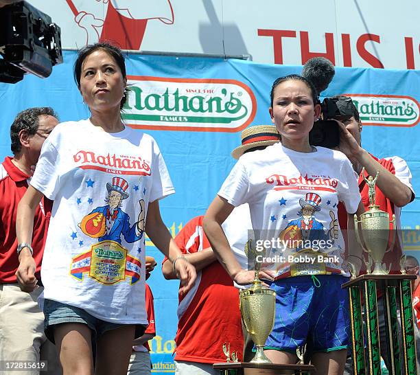 Sonya Thomas and Juliet Lee compete in the Woman's division of the 2013 Nathan's Famous Hot Dog Eating Contest at Coney Island on July 4, 2013 in New...