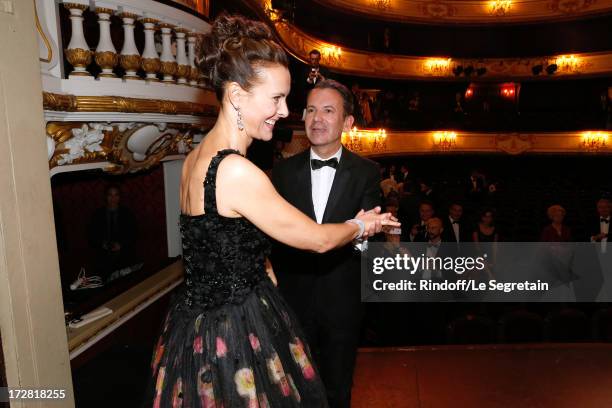 Actress Carole Bouquet and CEO Boucheron, Pierre Bouissou dancing on stage after a Show written by Muriel Mayette and an auction of stage costumes...
