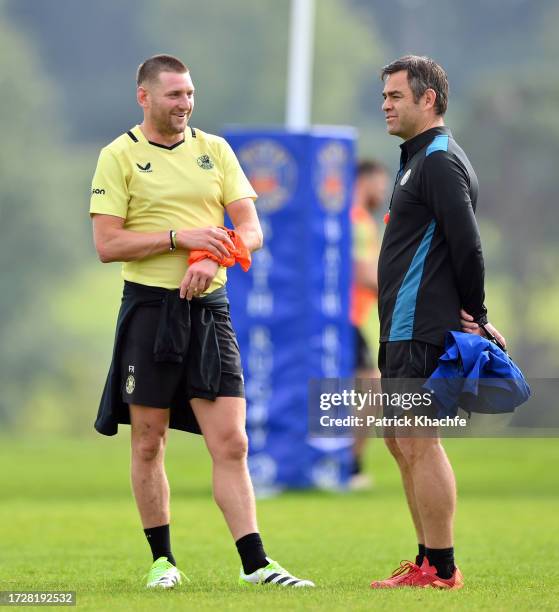 Finn Russell of Bath Rugby speaks with Head of Rugby Johann van Graan during a Bath Rugby training session at Farleigh House on October 10, 2023 in...