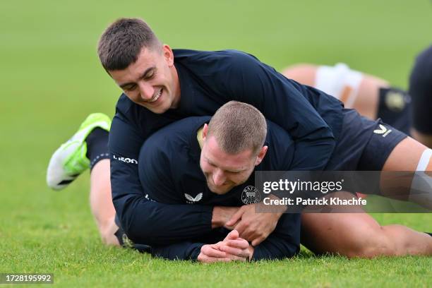 Finn Russell and Cameron Redpath of Bath Rugby wrestle during a Bath Rugby training session at Farleigh House on October 10, 2023 in Bath, England.