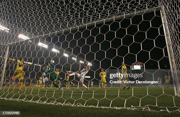 Goalkeeper Andy Gruenebaum of the Columbus Crew punches the ball clear as Robbie Keane of the Los Angeles Galaxy reaches for the ball in the second...