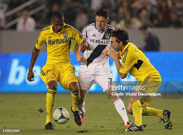 Kevan George and Danny O'Rourke of the Columbus Crew defend the play of Robbie Keane the Los Angeles Galaxy in the second half during the MLS match...
