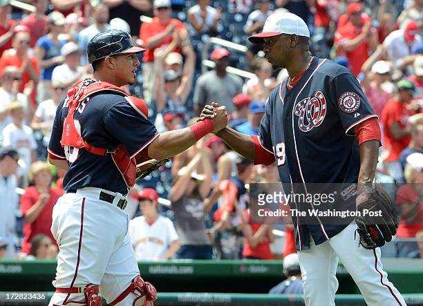 Washington Nationals catcher Wilson Ramos and Washington Nationals relief pitcher Rafael Soriano shake hands after the game between the Washington...