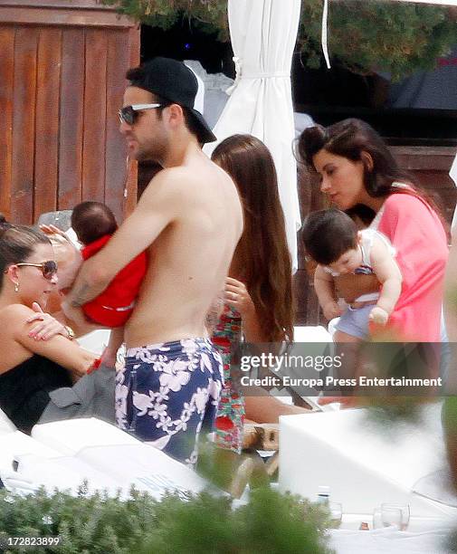 Barcelona football player Cesc Fabregas, his daughter Lia Fabregas and Leo Messi's girlfriend Antonella Roccuzzo and her son Thiago Messi are seen on...