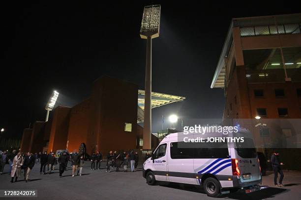 Supporters leave the King Baudouin Stadium as a Police van patrols following the Euro 2024 qualifying football match between Belgium and Sweden in...
