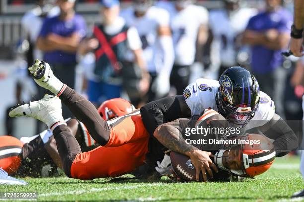 Dorian Thompson-Robinson of the Cleveland Browns is sacked by Patrick Queen of the Baltimore Ravens during the second half at Cleveland Browns...