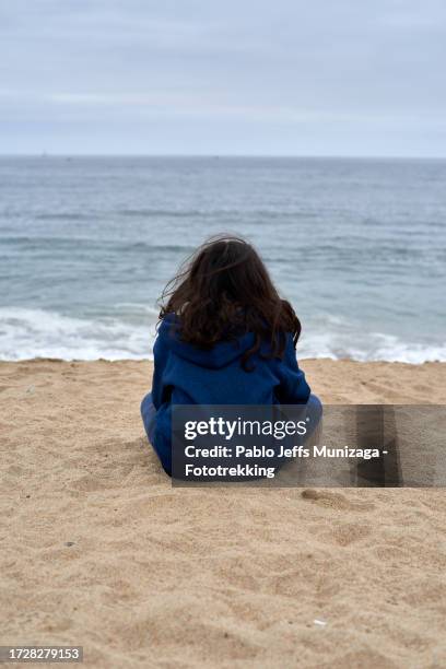 teenage boy sitting on the beach - viña del mar stock pictures, royalty-free photos & images