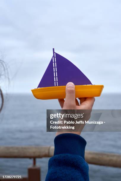 a toy boat in hand - viña del mar stock pictures, royalty-free photos & images