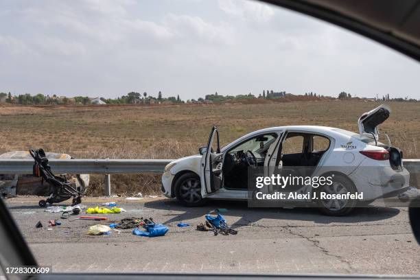 Baby stroller, along with other personal belongings are left on the side of the road next to a car after multiple civilians were killed days earlier...