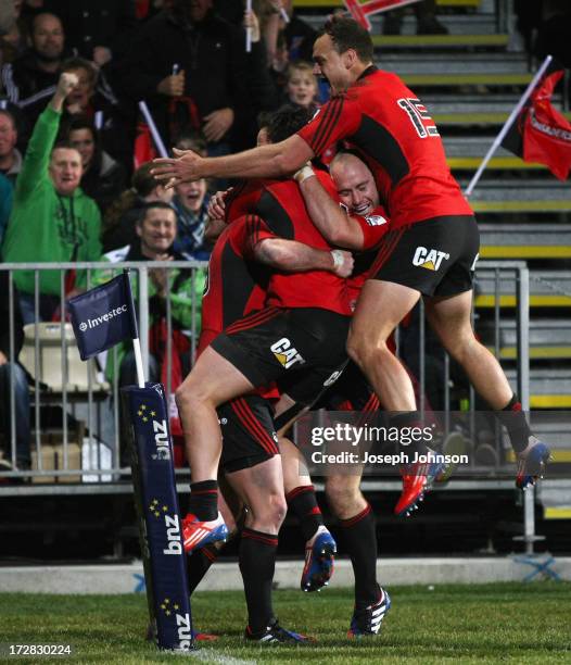 Tom Marshall of the Crusaders celebrates his try with team mate Zac Guildford, Willi Heinz and Israel Dagg running in during the round 19 Super Rugby...