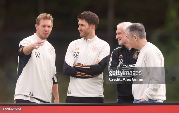 Julian Nagelsmann, head coach of Germany gestures to Benjamin Glück, assistant coach of Germany and Rudi Voller , DFB sports director and Andreas...