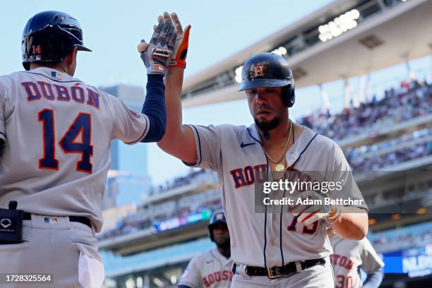 Mauricio Dubón and José Abreu of the Houston Astros celebrate after Abreu hit a home run in the first inning against the Minnesota Twins during Game...
