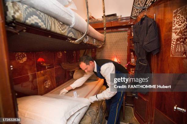 Member of staff make a bed on the Venice Simplon Orient Express train on February 28, 2013 at the Gare De L'Est Station in Paris. The train...