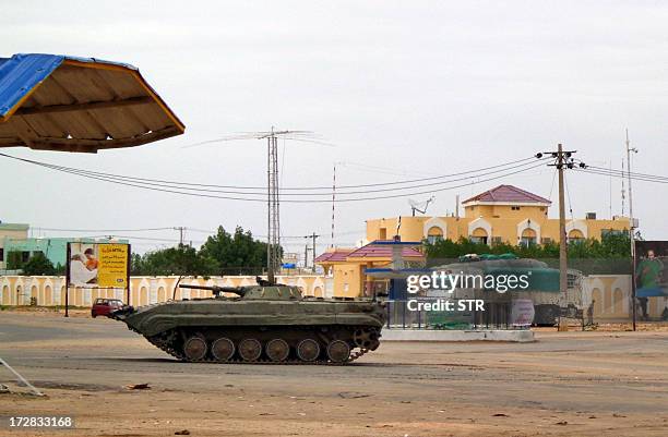 Sudanese military tank is stationed near a Sudanese security facility in the city of Nyala, in the Darfur region, on July 4 following an attack...