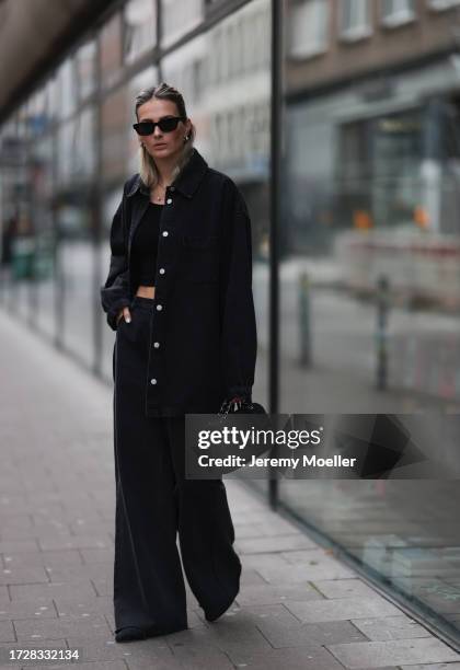 Kathrin Bommann is seen wearing black sunglasses from Céline, silver earrings and ear studs, the B.zero1 necklace in silver with diamonds from...
