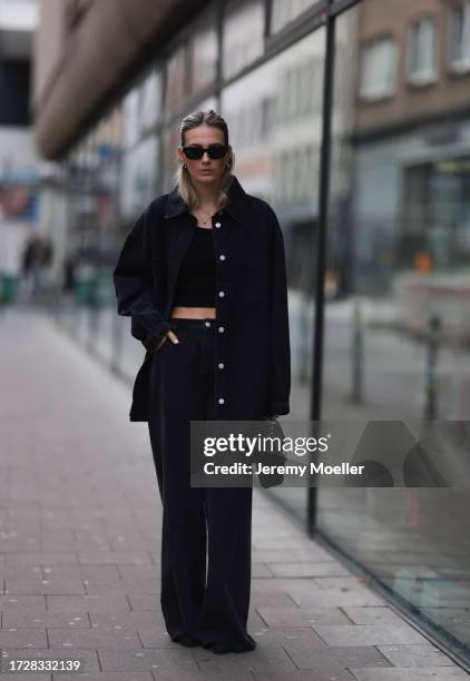 Kathrin Bommann is seen wearing black sunglasses from Céline, silver earrings and ear studs, the B.zero1 necklace in silver with diamonds from...